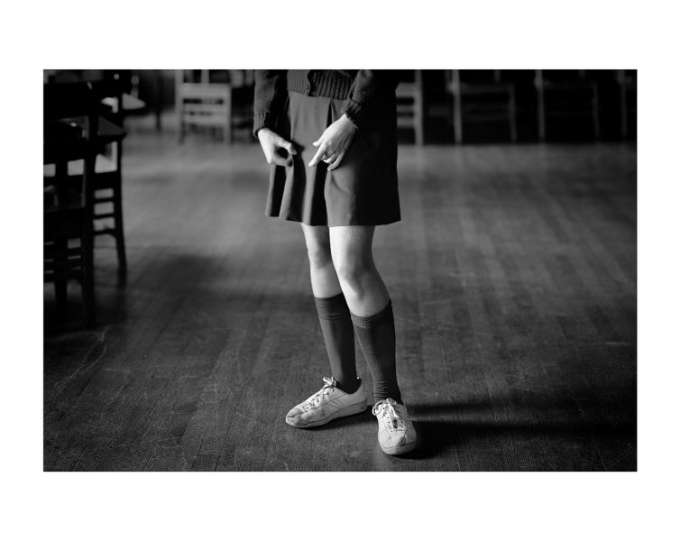 school girl in school room with sneakers